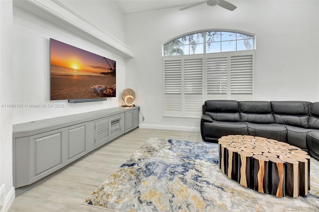 living room featuring ceiling fan and light hardwood / wood-style floors