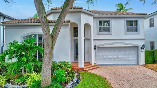 mediterranean / spanish-style home with a garage