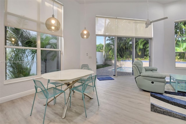 sunroom / solarium featuring plenty of natural light and ceiling fan