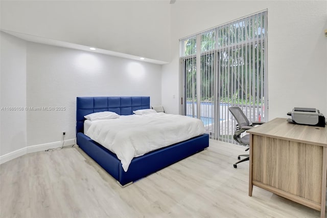 bedroom featuring light wood-type flooring and access to outside