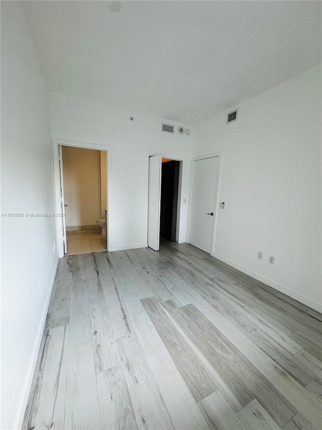 unfurnished bedroom with light wood-type flooring