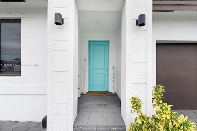 doorway to property with a garage