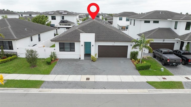 view of front of house featuring a garage and a front yard