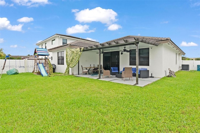 back of property with a playground, a lawn, an outdoor hangout area, central AC, and a patio area