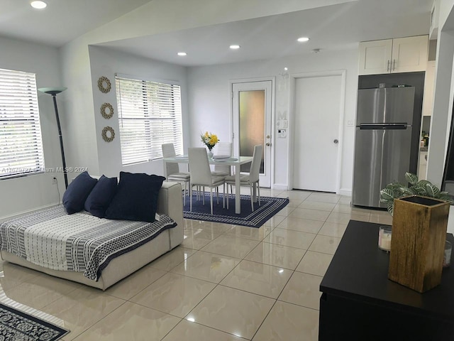 living room with light tile patterned floors and lofted ceiling