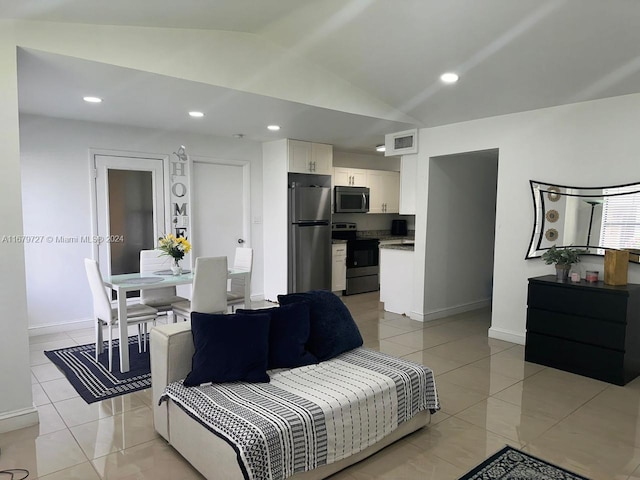 living room featuring light tile patterned flooring and vaulted ceiling