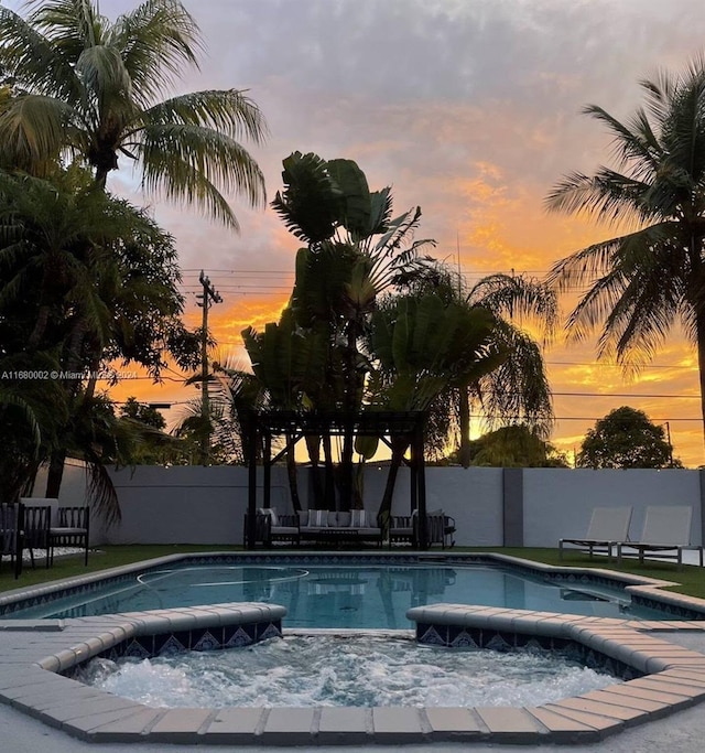 4384 SW 12th St, Miami, FL 33134 - pool at dusk with a patio area