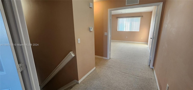 hallway featuring light carpet