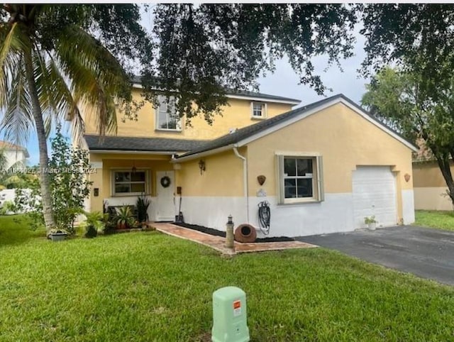 view of front facade featuring a garage and a front lawn