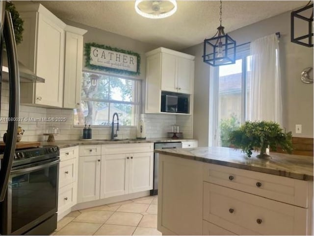 kitchen with white cabinetry, black range with electric cooktop, decorative backsplash, sink, and hanging light fixtures