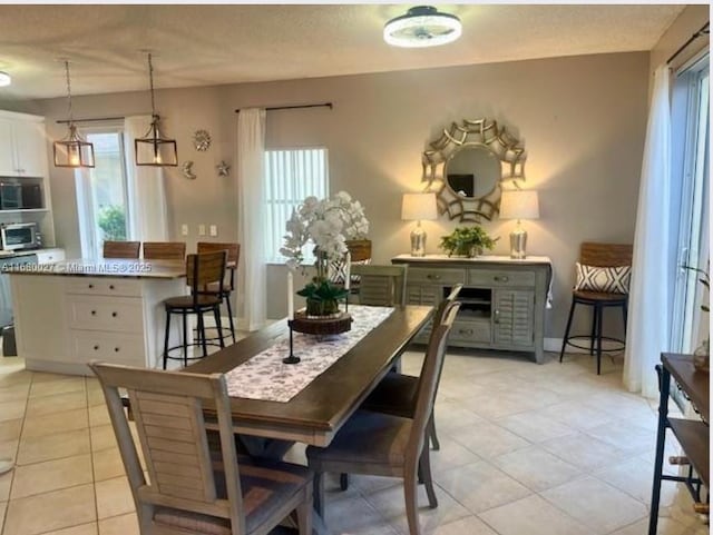 dining space featuring light tile patterned floors