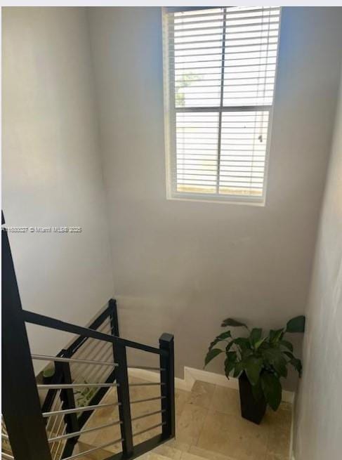 stairs with tile patterned floors