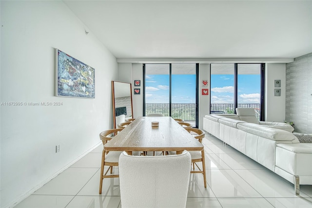 tiled dining area featuring a wall of windows