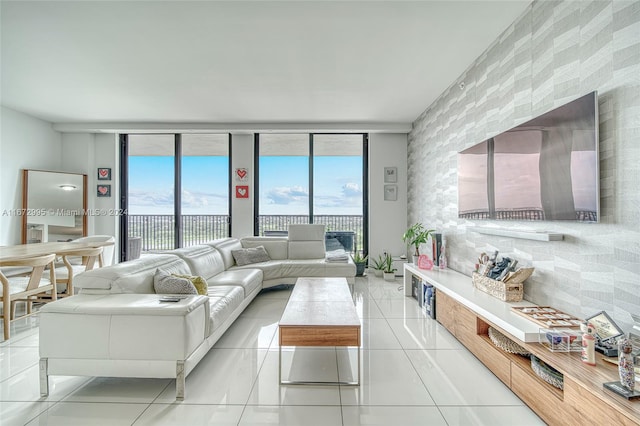 tiled living room featuring a wall of windows