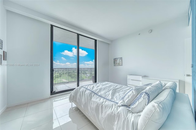 tiled bedroom with access to outside and floor to ceiling windows