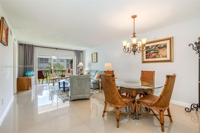 tiled dining room featuring a notable chandelier