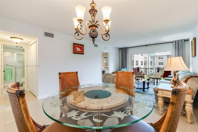 dining area with an inviting chandelier and light tile patterned floors