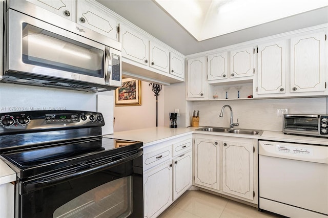 kitchen with black electric range, light tile patterned flooring, sink, white dishwasher, and white cabinetry