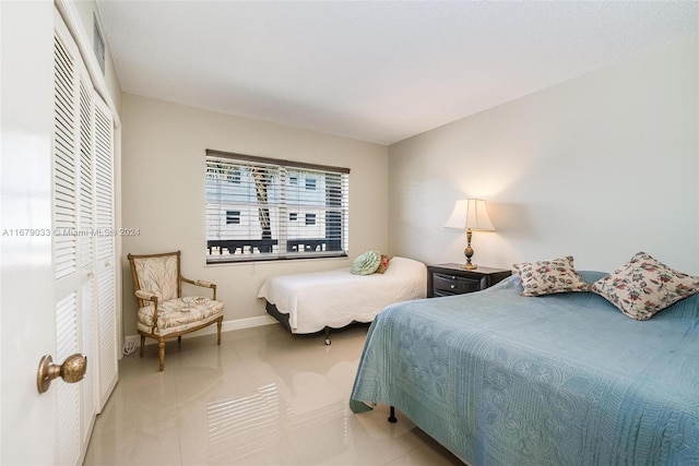 tiled bedroom featuring a closet