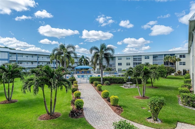 view of home's community featuring a yard and a pool