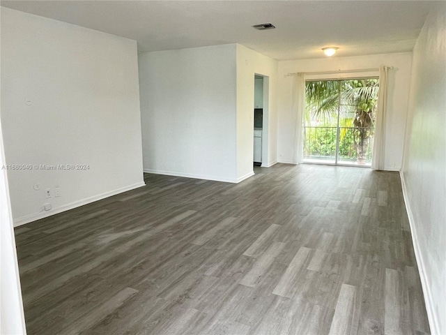 spare room with dark hardwood / wood-style floors