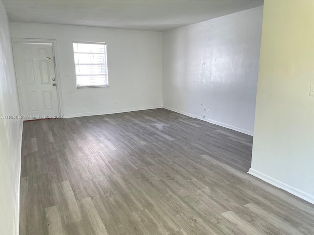 unfurnished room with hardwood / wood-style floors