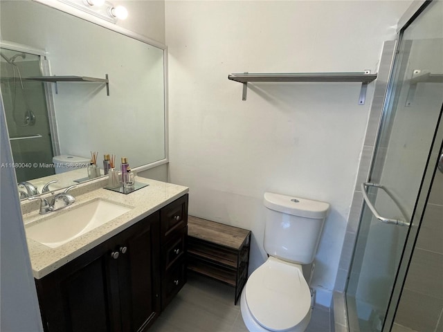 bathroom featuring toilet, vanity, and walk in shower