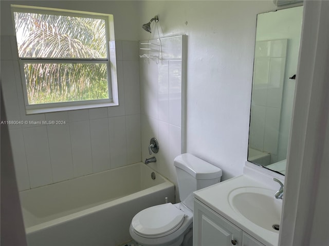 full bathroom featuring vanity, toilet, and tiled shower / bath