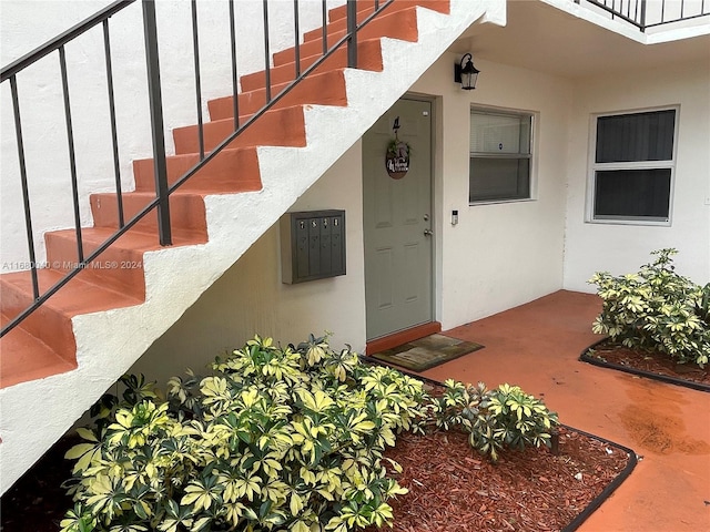 view of exterior entry featuring a balcony