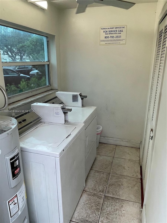 washroom with water heater, light tile patterned floors, and independent washer and dryer