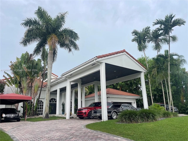 view of car parking with a carport and a lawn