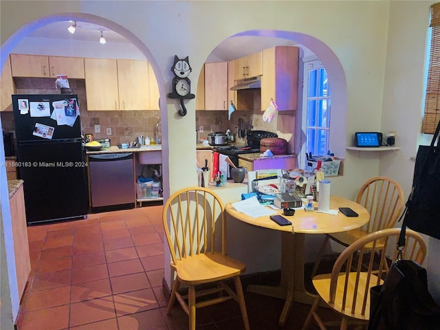 kitchen with tile patterned floors, black appliances, light brown cabinets, and tasteful backsplash