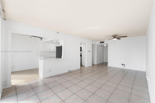 unfurnished living room with light tile patterned floors and ceiling fan