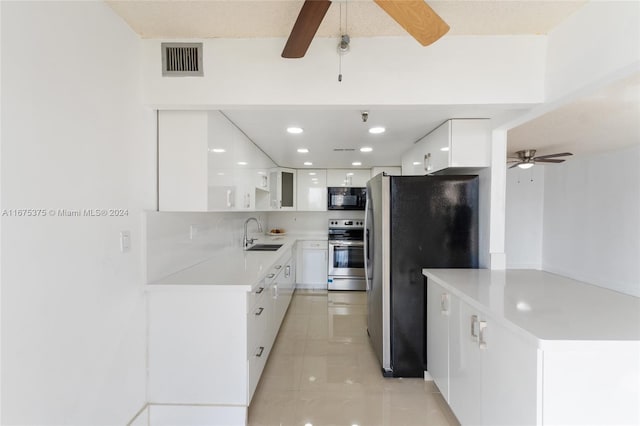 kitchen with backsplash, white cabinets, sink, and stainless steel appliances