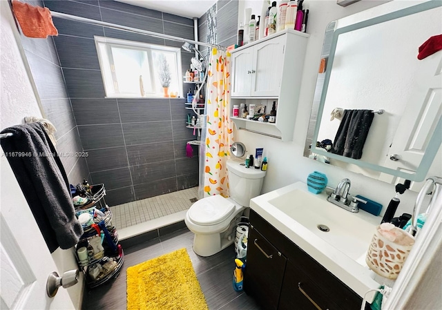 bathroom featuring a stall shower, vanity, and toilet