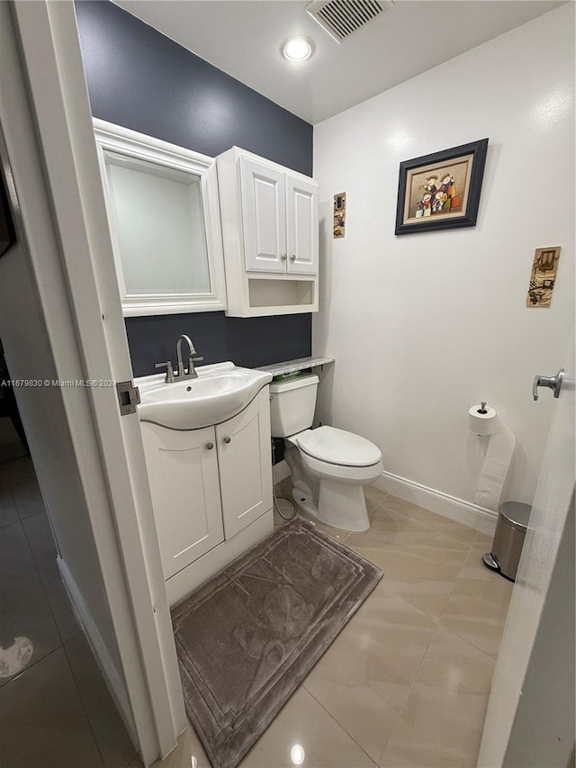 bathroom featuring vanity, toilet, and tile patterned floors