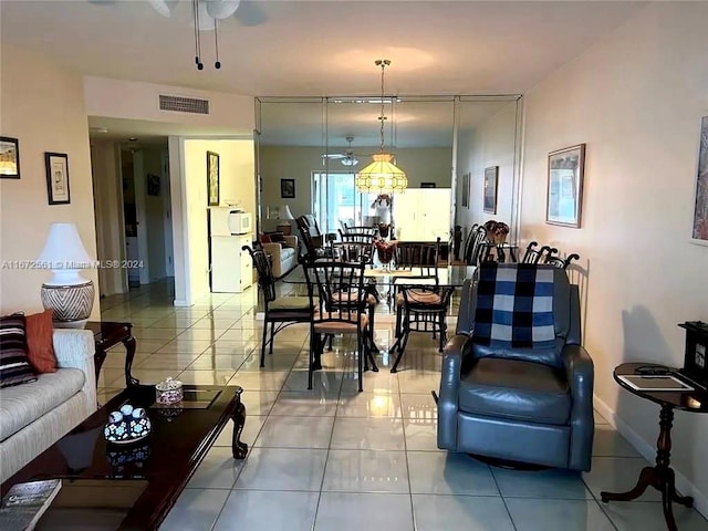 tiled living room with ceiling fan