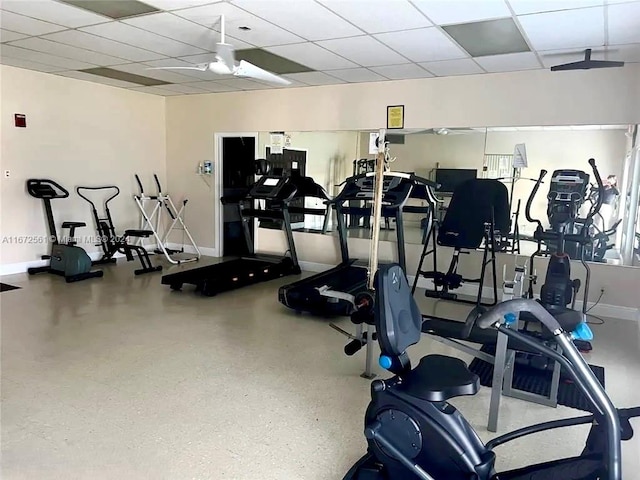 workout area with a drop ceiling and ceiling fan