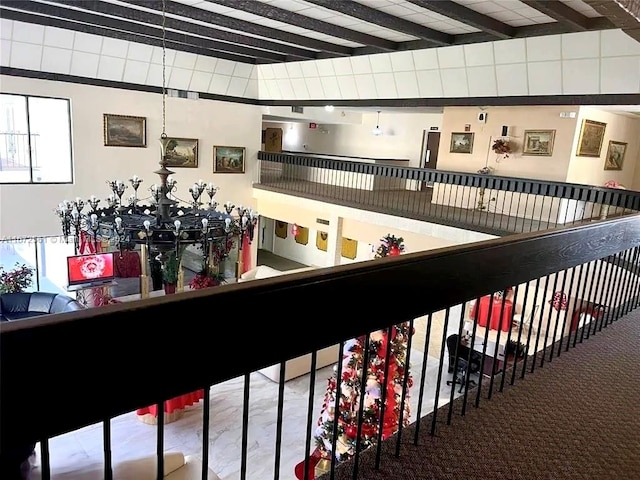 interior space with beam ceiling and carpet