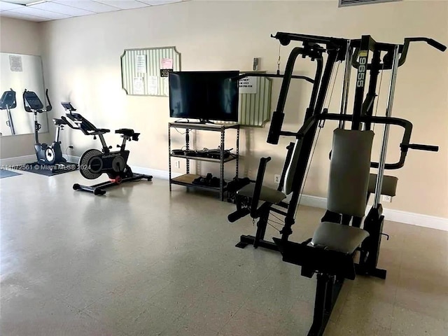 workout room with a drop ceiling