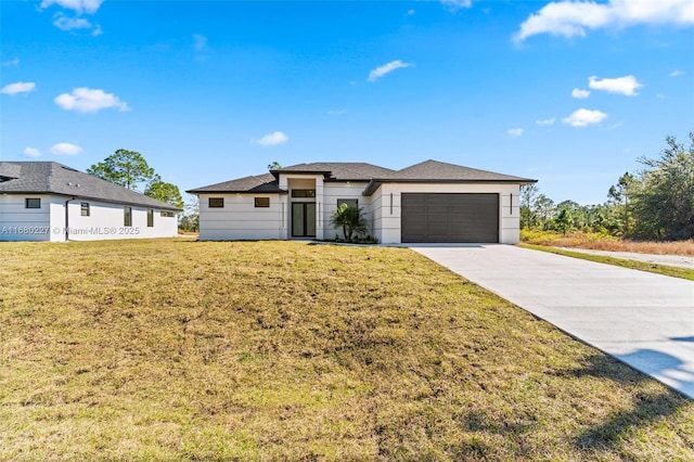 view of front of home featuring a garage and a front lawn