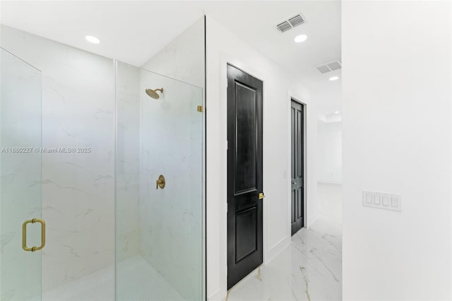 bathroom with a shower with door