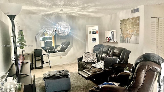 living room featuring a textured ceiling, a chandelier, and light tile patterned floors