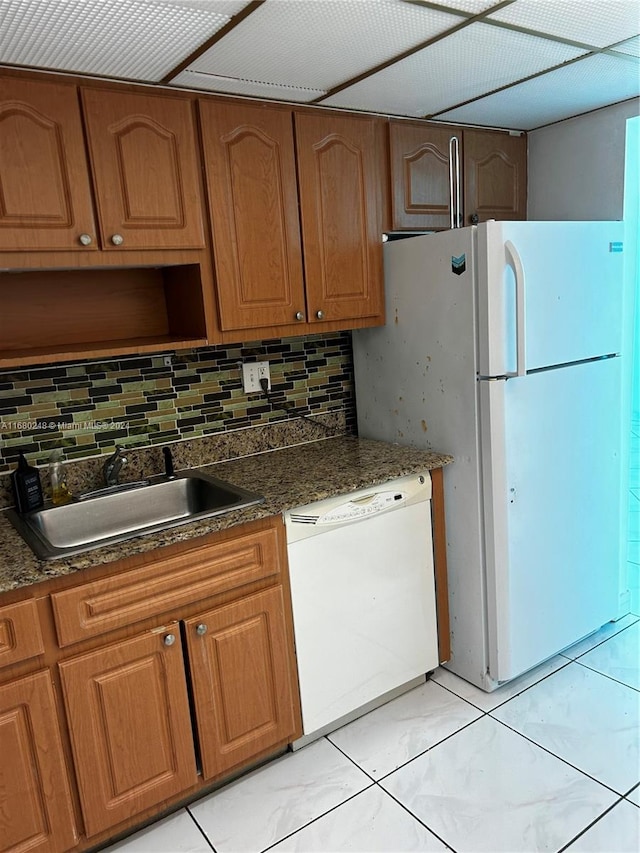 kitchen with decorative backsplash, sink, and white appliances