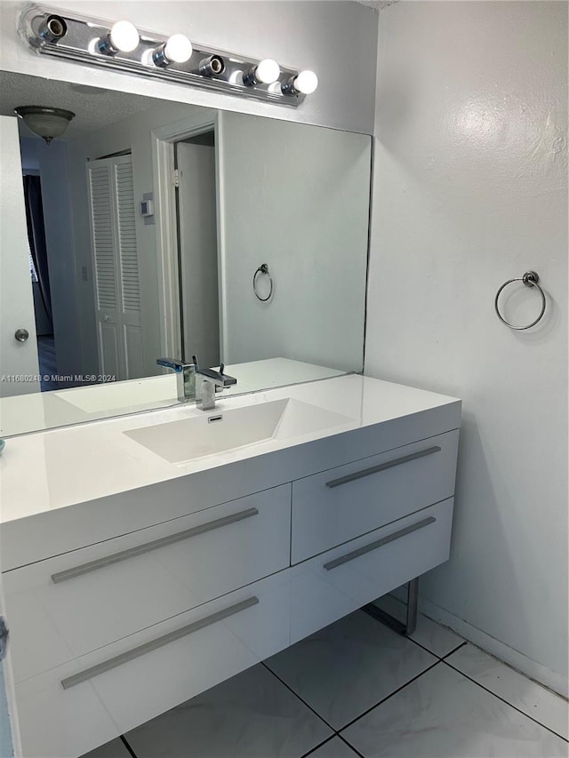 bathroom with vanity and tile patterned floors