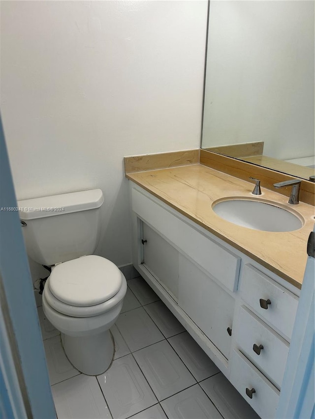 bathroom featuring vanity, toilet, and tile patterned floors