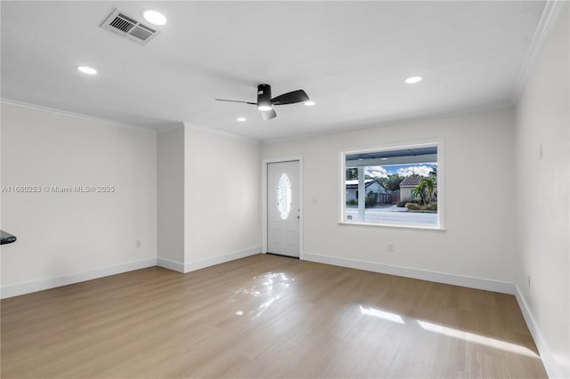 foyer entrance with crown molding, light hardwood / wood-style flooring, and ceiling fan