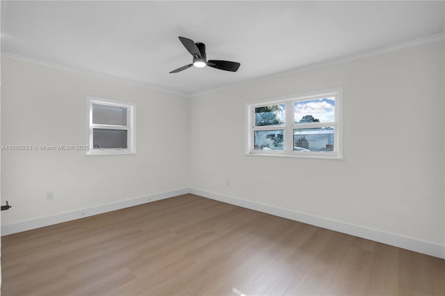 unfurnished room with crown molding, light wood-type flooring, and baseboards