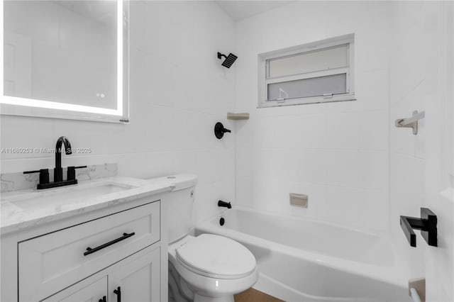 bathroom with bathtub / shower combination, vanity, and toilet