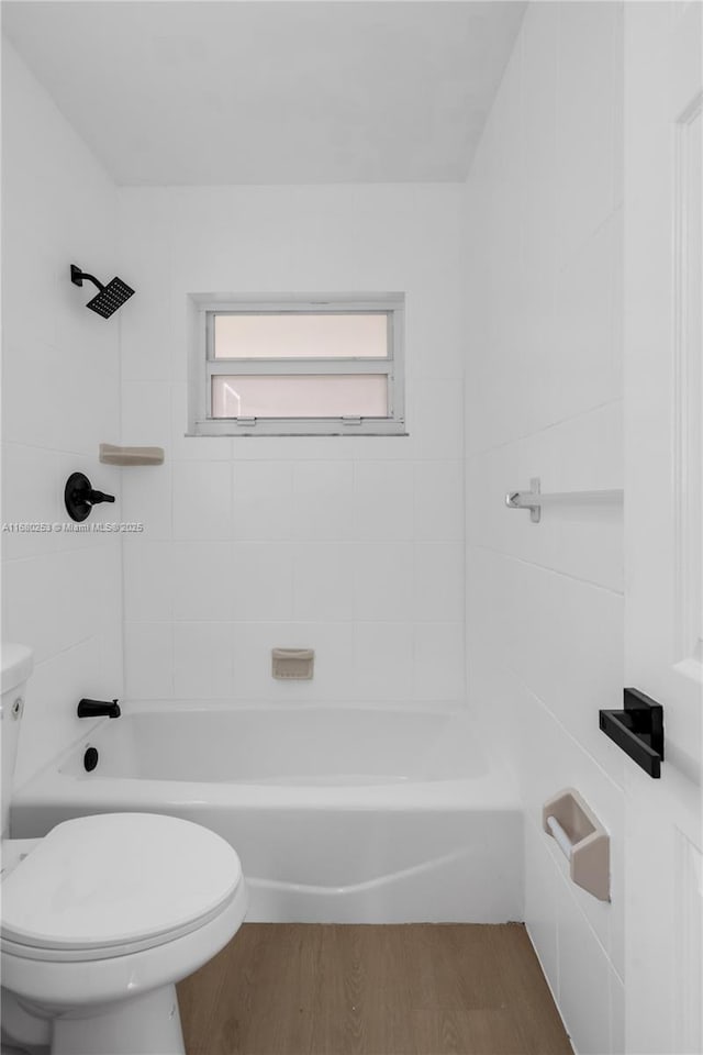 full bathroom featuring toilet, wood finished floors, and shower / bathtub combination